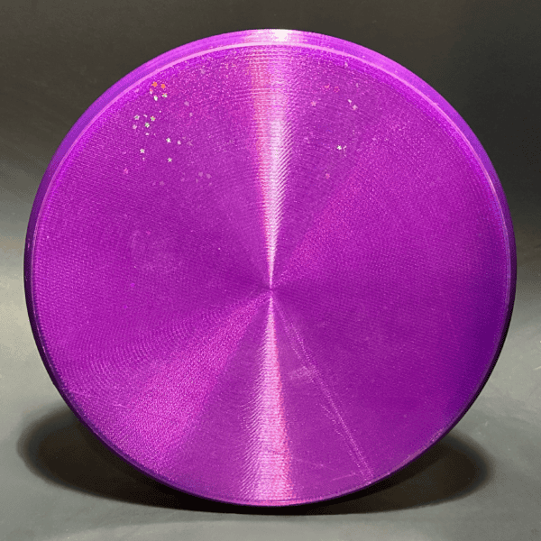 Purple disc golf disc with a metallic finish and small glitter details.
